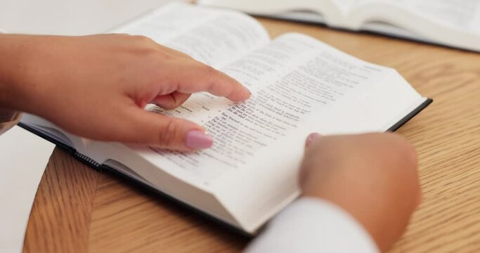 Hands, bible and person reading at table in home for religion, spiritual and worship Jesus Christ. Closeup, holy book and woman studying gospel for Christianity, scripture and praise God in house