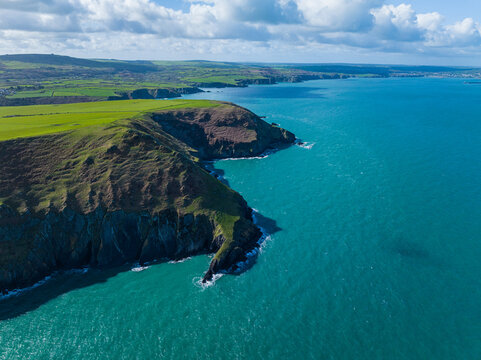 Aerial shot of Ynys Dinas headland and coastline looking towards Fishguard Bay, Pembrokeshire, West Wales