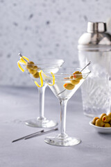 Lemon drop martini cocktail with olives and a lemon twist