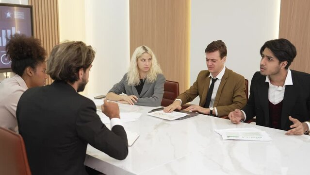 Stressful conflict tension during corporate meeting or business negotiation, diverse group business professional arguing about marketing plan with anger and serious argument in ornamented office.