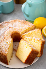 Lemon pound cake baked in a bundt pan topped with powdered sugar