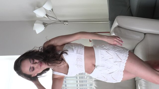 CFC2022VV  Ukrainian female model in casual setting dressed in knit white lingerie with cowboy hat 4K in vertical format