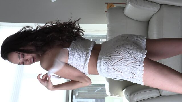 CFC2022VV  Ukrainian female model in casual setting dressed in knit white lingerie with cowboy hat 4K in vertical format