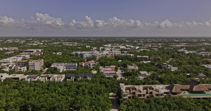Tulum Mexico Aerial v19 reverse flyover Outer luxury neighborhood capturing views of resorts, La Veleta and town center nestled in lush Mayan jungle forests - Shot with Mavic 3 Pro Cine - July 2023