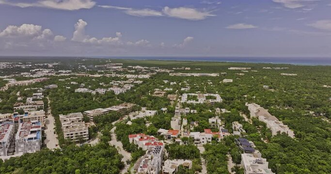 Tulum Mexico Aerial v12 drone flyover luxury residential neighborhood capturing new construction properties surrounded by lush forest and ocean landscape views - Shot with Mavic 3 Pro Cine - July 2023