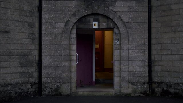 Open doorway of cinder block building on a dark spooky evening