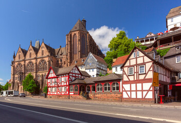 Medieval street with traditional half-timbered houses and University Church, Marburg an der Lahn, Germany