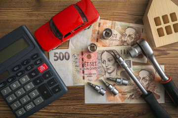 Calculator, Pen, and Various Items Arranged on a Table Pile of Czech crown banknotes concept of inflation home economics car ownership cost in Czechia