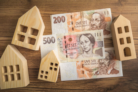 Wooden Houses and Czech crown banknotes on a Wooden Table home economics and inflation in Czechia 