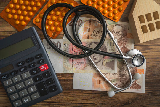 Medical Supplies and Calculator on Wooden Table Pile of Czech crown banknotes concept of inflation and financial health home economics in Czechia