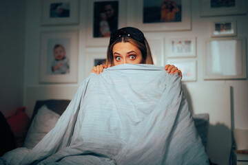 Shy Girlfriend Hiding under the Blanket Feeling Embarrassed. Shocked surprised woman feeling...