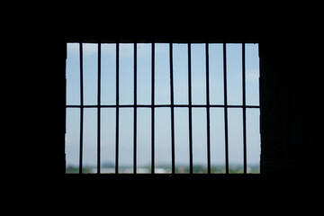 The prisons iron bars with a refreshing view beyond