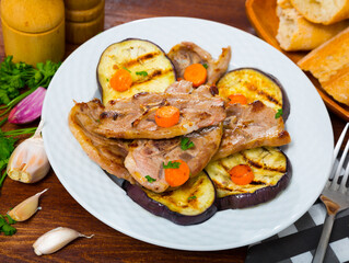 Appetizing grilled lamb chops with vegetable garnish of eggplant, carrots and greens
