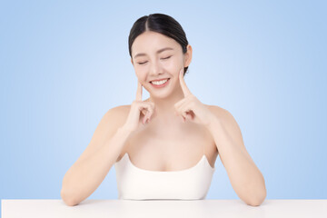 Close-up portrait of young Asian beautiful woman with healthy skin isolated on light blue background for skincare commercial product advertising.