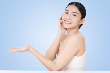 Close-up portrait of young Asian beautiful woman with healthy skin isolated on light blue background for skincare commercial product advertising.