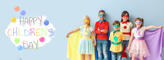 Cute little children dressed as superheroes on color background