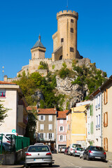 View of impressive medieval castle on rocky outcrop in French commune of Foix..