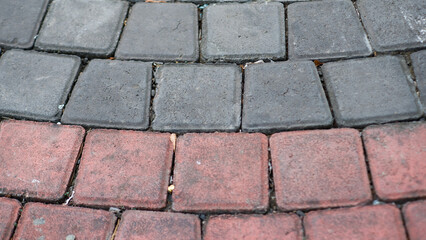closeup grey-red paving stones city landscape