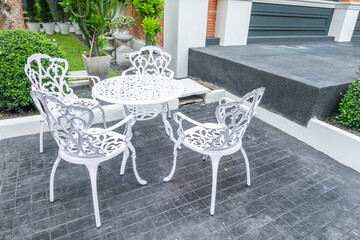 Classic white steel chair and table in the garden,empty white vintage chairs in the garden,decoration english garden concept.
