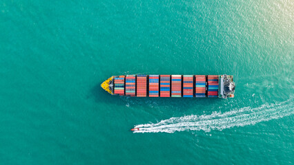 Top view Cargo Container ship the ocean ship carrying container and running for import export...