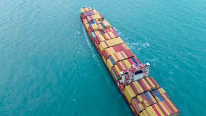 Top view Cargo Container ship the ocean ship carrying container and running for import export...