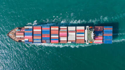 Top view Cargo Container ship the ocean ship carrying container and running for import export concept technology freight shipping by ship . aerial top of Container Vessel running in green sea.