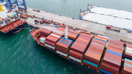 Crane loading box container to cargo ship at commercial dock port. Shipyard Cargo Container Sea...