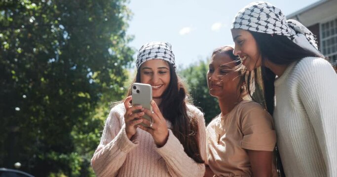 Women, phone or scarf as social media, post or update as online activism to free Palestine. Happy, Muslim girls or mobile to share, viral or communication as community, support or bonding together