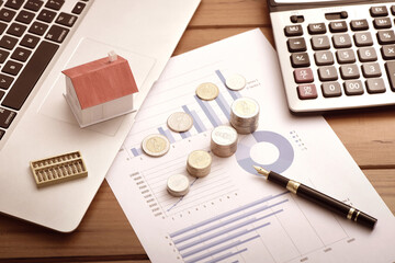 Office supplies, coins, and small houses on the data blueprint