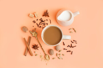 Cup of tasty masala tea with different spices on beige background