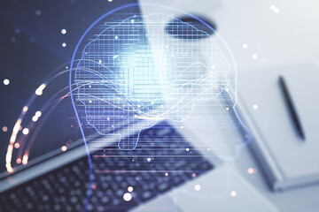 Double exposure of creative artificial Intelligence symbol with modern laptop on background. Neural...