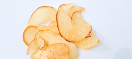 Heap deep fried cassava chips close up isolated on white background