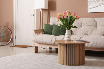 Vase with beautiful tulips in interior of living room