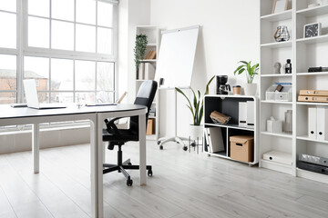 Interior of modern office with table prepared for meeting