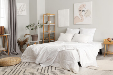 Interior of stylish bedroom with paintings on wall
