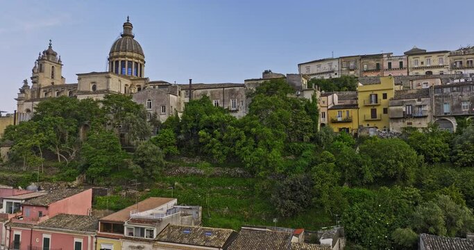 Ragusa Italy Aerial v8 elevated shot capturing charming residential townhouses of Ibla town, followed by a tilt-down bird's-eye view above Cathedral of San Giorgio - Shot with Mavic 3 Cine - June 2023