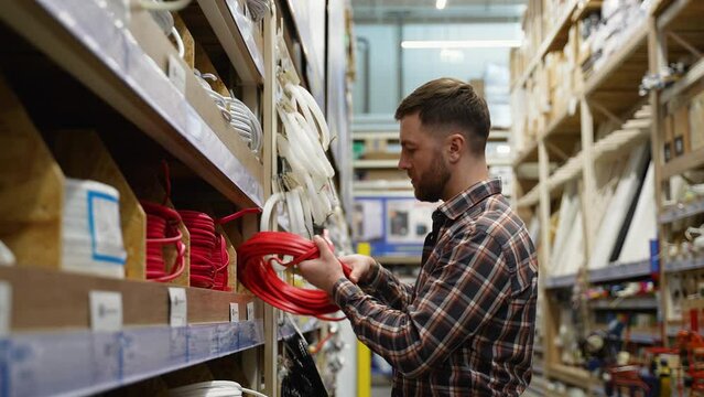 Electrician sells electrical cables in a hardware store