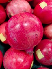Batam, Indonesia - 16 April 2024: Fresh fruit. Piles of pomegranates are sold in neatly arranged supermarkets.