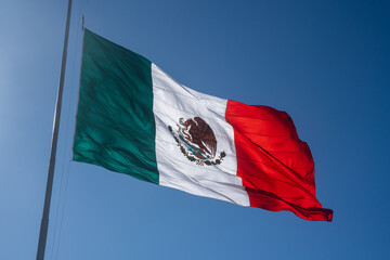 Mexican flag on a sunny and windy day