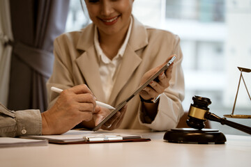businesswoman Handing an electronic document on a tablet for a businessman to sign