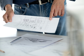 Engineers and architects are looking at the plans of the construction project consulting to plan the