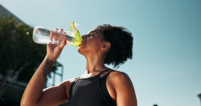Fitness, wellness and woman drinking water for hydration, workout and training for health outside. Tired runner, cardio exercise and liquid for resting or energy, break and active in summer