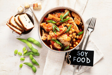 Soybean with soy meat, onion and tofu on light wooden background. Vegan food