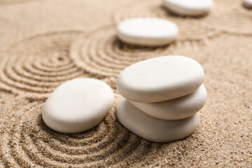 Fototapeta na wymiar Zen stones on sand with pattern