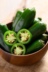 Fresh green Jalapeno chili in wooden bowl, Food ingredient