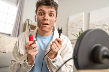 Electrocuted man with burnt face repairing lamp at home, closeup