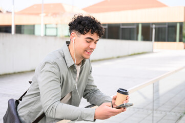 portrait of young man listening to music and enjoying coffee