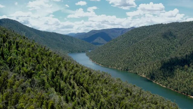 Forward aerial shot of Snowy river near Mount Kosciuszko National Park in Australia.