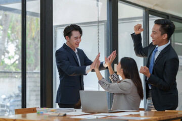 Great job! Successful business team is clapping their hands in modern workstation, celebrating the...