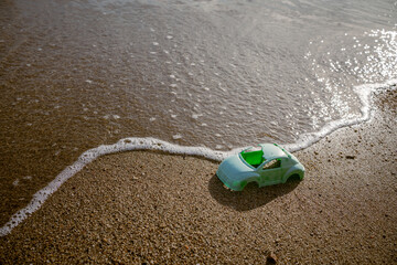 Plastic waste at the seashore. Car passing the coast. Tsunami concept.